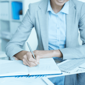 Businesswoman writing in a journal