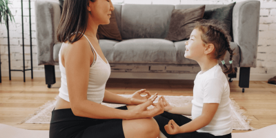 A woman meditating with her daughter