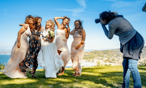 A photographer photographing a group of women.