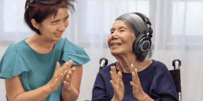 A music therapist working with an elderly patient