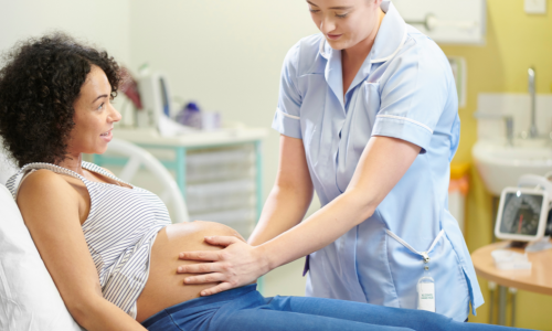 A midwife working with a pregnant woman
