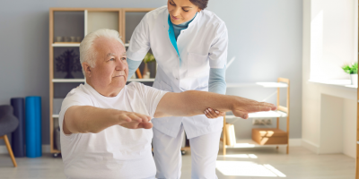 Physical therapist working with an elderly patient