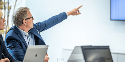Man pointing at a PowerPoint presentation