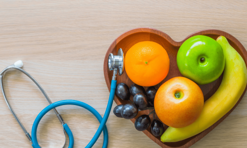 A stethoscope and fruit, illustrating nutrition