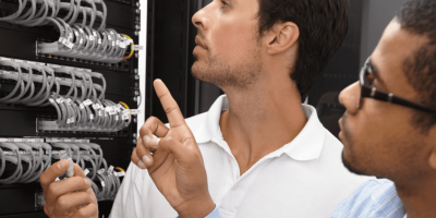 Two men troubleshooting a computer network