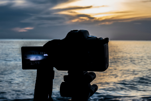 A digital camera photographing a sunset