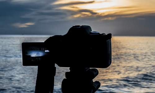 A digital camera photographing a sunset